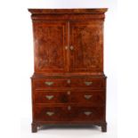 George I burr walnut cabinet on chest, the concave cornice above a frieze drawer and a pair of