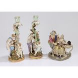 Pair of Meissen porcelain figural candlesticks, each with a scroll and swag tree trunk forming the