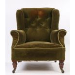 Howard & Sons style Edwardian armchair, the button back with out swept pads above the deep seat