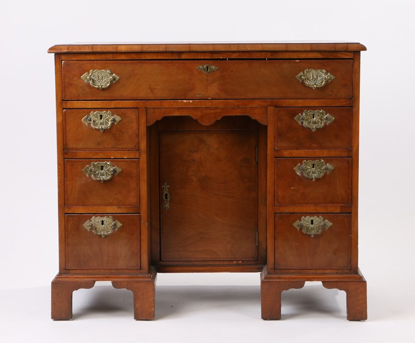 George III mahogany and feather banded kneehole desk, the rectangular top above seven drawers