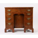 George III mahogany and feather banded kneehole desk, the rectangular top above seven drawers