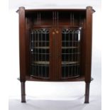 Art Nouveau style mahogany cabinet, the rectangular top with shaped corners above the finial gallery