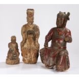 A collection of Chinese altar figures, to include a seated figure with a red robe and necklace, 44cm