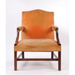 George III mahogany Gainsborough armchair, the serpentine top above a pad back and stuff over seat