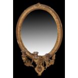 19th Century gilt wall mirror, the oval mirror plate with an egg and flower edge and a three