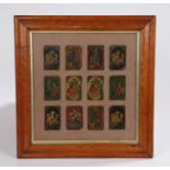 Collection of twelve Persian Qajar lacquer playing cards, with figures and animals, mounted in a