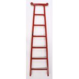 Chinese red lacquer ladder, with a shaped top rail above the tapering steps, 199cm high