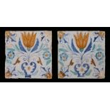 Pair of 17th Century Dutch Delft tiles, circa 1650, the polychrome faces decorated with tulips to