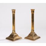 Pair of 18th Century brass candlesticks, the sockets above gadrooned stems and sweeping bases,