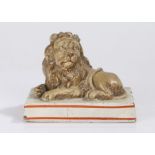 George III Wood & Caldwell pearlware lion, circa 1800, recumbent on rectangular base highlighted