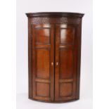 George III oak hanging corner cabinet, the dentil moulded cornice above blind fret top and sides and