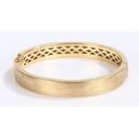 18 carat gold bangle, with lightly engine turned crisscross decoration, 24 grams, 70mm diameter