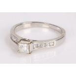 18 carat white gold diamond set ring, with a quadrillion cut diamond to the head and flanked by five