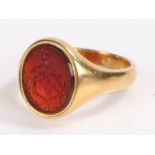 Signet ring, the red intaglio with an heraldic crest set within a yellow metal shank, ring size R1/