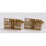 Pair of 14 carat gold cufflinks, the heads in the form of abacuses with sliding beads, 7.7g