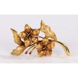 9 carat gold and garnet set brooch, in the form of flowers set with garnets, 55mm long, 7 grams