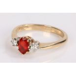 9 carat gold garnet set ring, with a central garnet flanked by cubic zirconia, ring size N