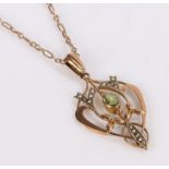 Art Nouveau peridot and pearl set pendant necklace, with a central peridot and arched fret surround,