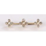 Diamond and pearl brooch, with three cross sections set with a central pearl and diamond surround to