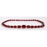 Cherry amber beads, with a row of graduated beads tapering from the front to the end
