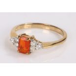 9 carat gold ring, set with a central baguette orange stone flanked by diamonds, ring size N1/2