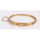 Victorian ruby pearl and sapphire set bangle, the gemstones set to a foliate design, 62mm diameter
