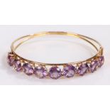 Amethyst mounted bracelet, set with nine amethysts to the tapering bracelet, 60mm diameter