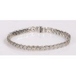 9 carat white gold tennis bracelet, set with an estimated total of one carat of diamonds, 19cm long