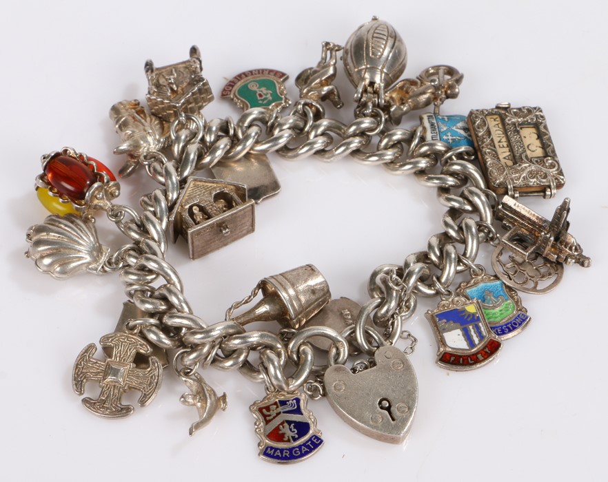 Silver charm bracelet, with various charms attached, 102 grams