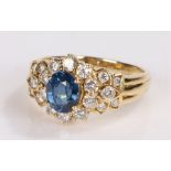 18 carat gold sapphire and diamond set ring, the central oval sapphire and a round cut diamond