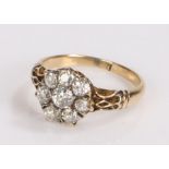 18 carat gold and diamond ring, the central diamond surrounded by a further seven diamonds in a
