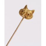 Yellow metal fox head stick pin, set with red eyes, the head 16mm diameter