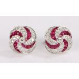 Pair of 18 carat white gold ruby and diamond set earrings, the studs set with a curved ruby and