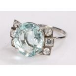 Aquamarine and diamond set ring, the central 8.28 carat aquamarine with three diamonds to either