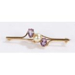 9 carat gold pearl and amethyst set brooch, with a central pearl flanked by amethyst, 51mm diameter