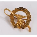 9 carat gold brooch, the horseshoe shaped back with central riding crop and dogs head in profile,