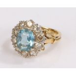 18 carat gold aquamarine and diamond ring, the central aquamarine with a diamond surround, ring size