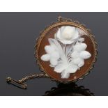 9 carat gold cameo brooch, the panel carved with a rose, housed in a pierced arched mount, with