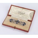 Diamond and sapphire set brooch, set with 4.60 carats of sapphires and an estimated 0.64 carats of