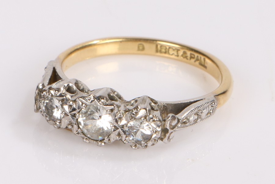 18 carat gold and diamond set ring, with three round cut diamonds to the head, ring size L