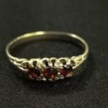 9CT GOLD AND GARNET 3 STONE RING