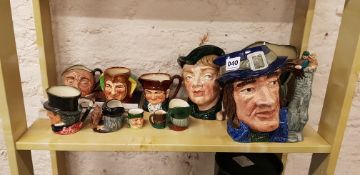 SHELF LOT OF DOULTON CHARACTER JUGS AND BOOK