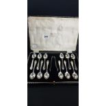 CASED SET OF 12 SILVER SPOONS AND PAIR OF SILVER SUGAR TONGS - SHEFFIELD 1929/30