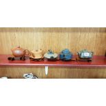 5 MINIATURE ORIENTAL TEAPOTS ON STANDS