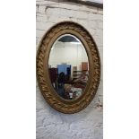 LARGE OVAL GILT MIRROR