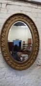 LARGE OVAL GILT MIRROR