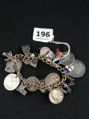 HEAVY SILVER CHARM BRACELET WITH ASSORTED COINS & CHARMS