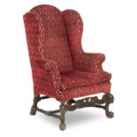 A 19th century walnut wingback upholstered armchair