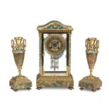 A late 19th/early 20th century French champleve enamel and onyx clock garniture