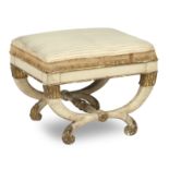 A white painted and carved giltwood Regency stool